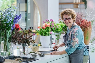 Professional female florist smiling and looking at camera